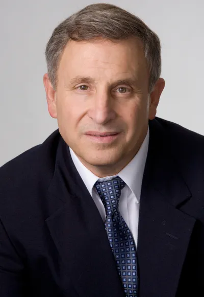 Headshot of Ray Ciancaglini, a man in a dark suit and patterned tie, looking forward.