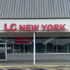LC NEW YORK storefront with a "Now Open!" sign in a Finger Lakes strip mall.