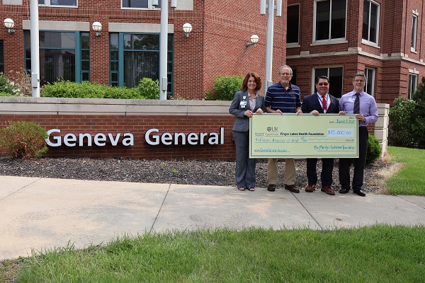 Four people pose with a large $15,000 check from Finger Lakes Health Foundation in front of Geneva General Hospital.