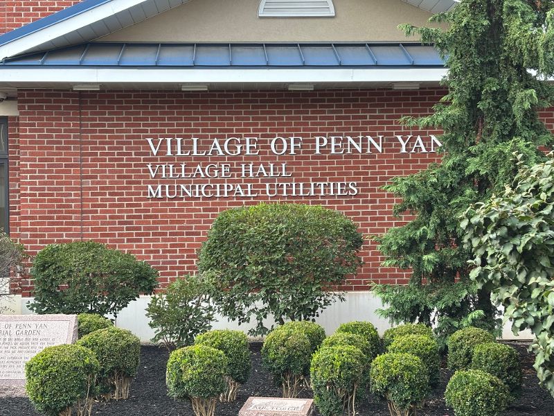 Exterior of the Village of Penn Yan Village Hall and Municipal Utilities building, with a brick facade and landscaping.