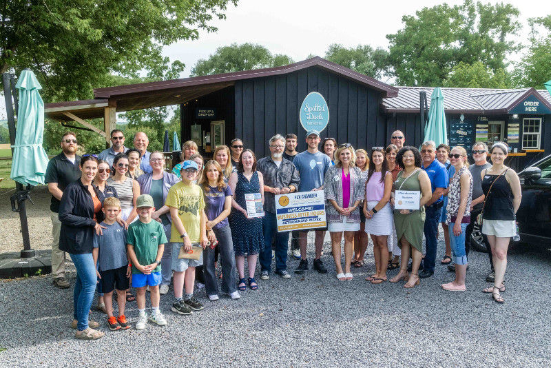 Group poses at The Spotted Duck ice cream stand in Penn Yan for a Finger Lakes Chamber of Commerce event.