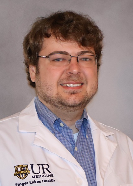 Headshot of Dr. Daniel Petreccione, a smiling man with glasses, wearing a white UR Medicine - Finger Lakes Health lab coat.