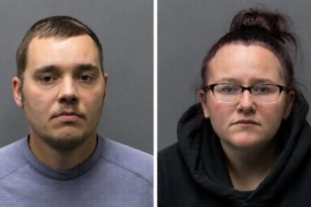 Mugshots of a man with short hair and a woman with glasses, both charged in a 12-day-old infant's death.