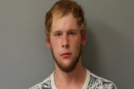 Mugshot of Bradley Smith, a young white man with reddish-blonde hair and a beard, looking forward.