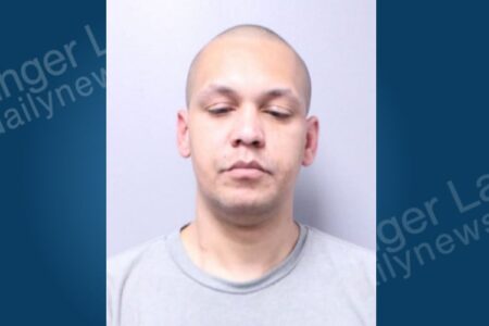 Mugshot of Brandin Brown, a bald man with light skin, wearing a grey shirt, arrested in Moravia.