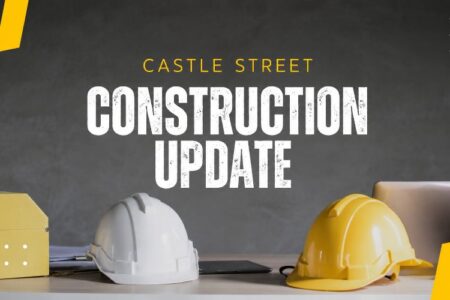 Graphic with 'Castle Street Construction Update' text, featuring a yellow house model and two hard hats.
