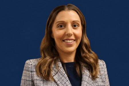 Headshot of Dr. Megan Molina, the new Pupil Services Leader for Victor Schools, smiling against a blue background.