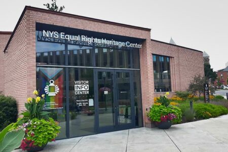 Exterior view of the NYS Equal Rights Heritage Center in Auburn, a brick building with a Visitor Info Center sign.