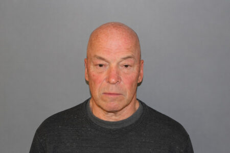 Mugshot of bald man Frank Schmitter, Seneca Falls Supervisor, against a grey background.