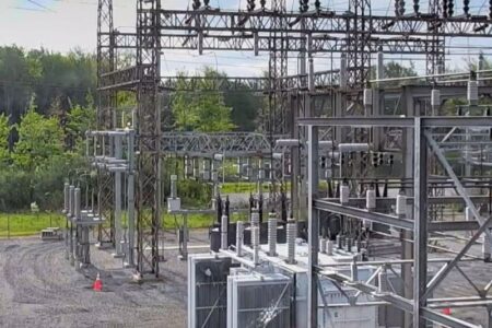An electrical substation with transformers, insulators, and power lines, likely related to a power outage in upstate NY.