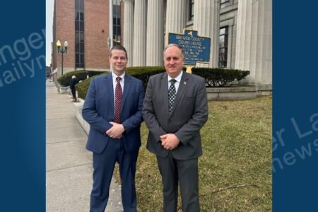 Cayuga County Sheriff Brian Schenck and his successor, Lieutenant Franklin, stand outside the courthouse.
