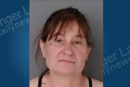 Mugshot of Sheri King, a woman with brown hair and bangs, looking directly at the camera.