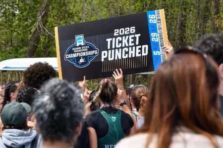 A crowd celebrates as a large sign reads '2026 NCAA DIII Rowing Championships Ticket Punched', with a rowing shell in background.