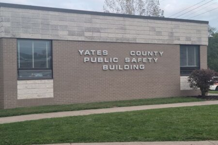 Exterior view of the Yates County Public Safety Building with a brick facade and large windows.