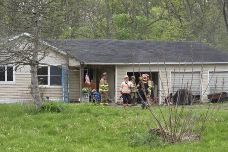 Firefighters respond to a house fire in Bellona, with smoke visible from the structure and garage.