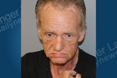 Mugshot of an older white man with light hair, looking directly at the camera with a somber expression.