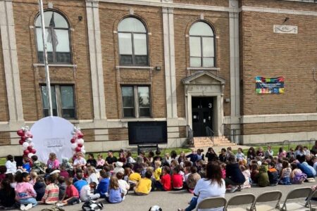Children gathered outside Perkins School for its 100th anniversary celebration.