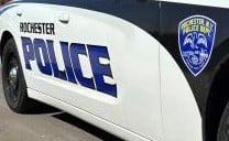 Side of a Rochester Police Department patrol car with 'ROCHESTER POLICE' written on it and the department's emblem.