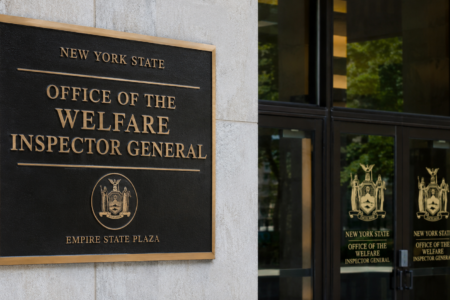 Plaque for the New York State Office of the Welfare Inspector General on a building wall.