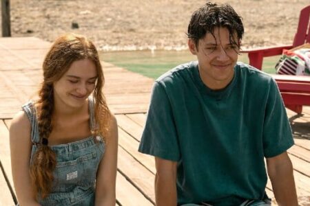 Sadie Soverall and Matt Cornett smile on a wooden dock by a lake in 'Every Year After.'
