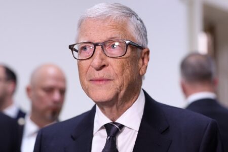Bill Gates in a suit and glasses, appearing before an oversight panel.