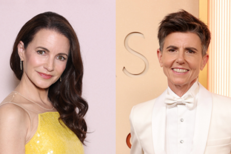 Kristin Davis in a yellow dress and Tig Notaro in a white tuxedo, smiling.