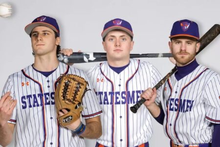 Three Hobart Statesmen baseball players in uniform, two with bats, one with a glove, with a baseball in the air.