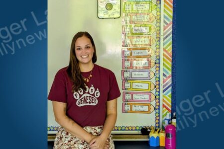 Holly Signor, an Auburn teacher, smiles in her classroom after saving a choking student.