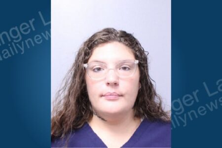 Mugshot of JAnne Mizro, a woman with curly brown hair and glasses, arrested for felony welfare fraud.
