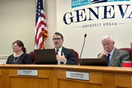 Geneva Mayor Jim Cecere speaks at a City Council meeting with Councilor John Brennan and another official.