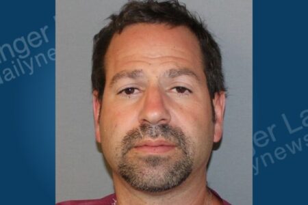 Mugshot of Kristopher Jeffers, a man with dark hair and a goatee, facing domestic incident charges.