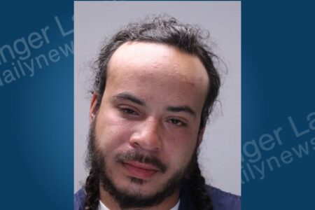 A mugshot of Kurtis Freeman, a man with dark curly hair and a beard, arrested in Farmington, NY.