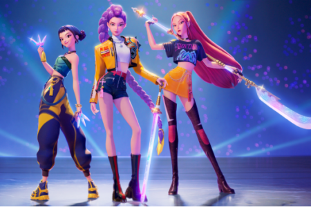 Three animated female characters, 'KPop Demon Hunters,' in dynamic poses with glowing weapons on a blue stage.