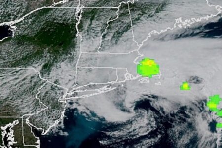 Satellite image of New England and Atlantic Ocean with green/yellow highlights indicating a meteor event.