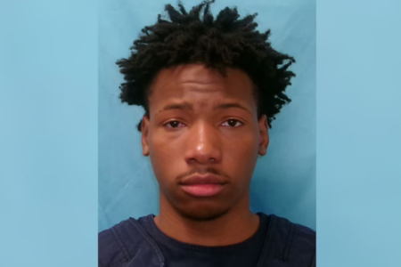 Mugshot of Karmelo Anthony, a young Black man with short dark hair, looking directly at the camera.