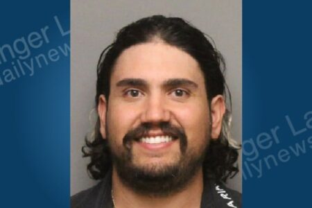 Mugshot of Salvatore Magro, a man with dark hair, beard, and mustache, smiling.