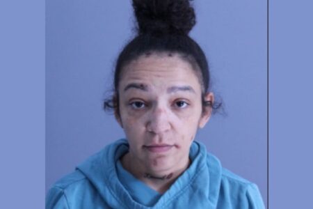 Mugshot of Shaniqura Bailey, a woman with dark hair in a bun, wearing a blue hooded sweatshirt.