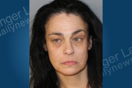 Mugshot of Shelly Baran, a woman with dark hair and light eyes, facing a drug charge.