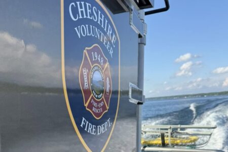 Cheshire Volunteer Fire Dept. boat on Canandaigua Lake, leaving a wake during a search operation.