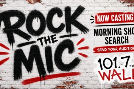 Graffiti-style 'Rock The Mic' logo on a brick wall with 'Now Casting Morning Show Search' and '101.7 The WALL'.